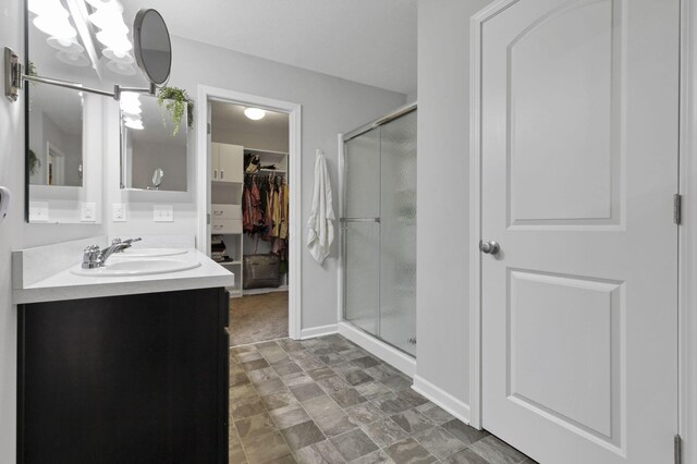 7142 Duke Dr, Canal Winchester, OH 43110 - bathroom with a shower stall, vanity, a walk in closet, and a chandelier