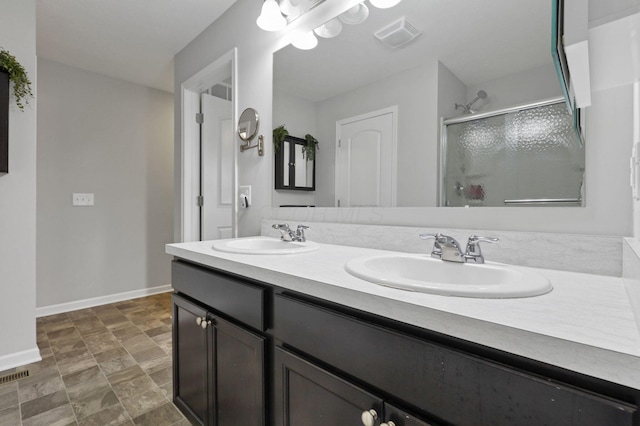 7142 Duke Dr, Canal Winchester, OH 43110 - bathroom with baseboards, double vanity, a stall shower, and stone finish floors