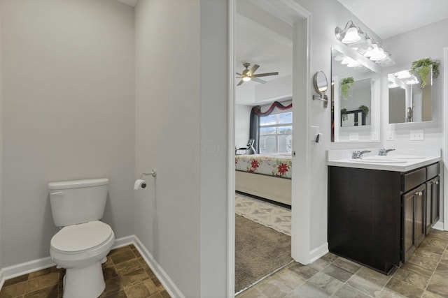 7142 Duke Dr, Canal Winchester, OH 43110 - ensuite bathroom with toilet, vanity, a ceiling fan, baseboards, and stone finish floors