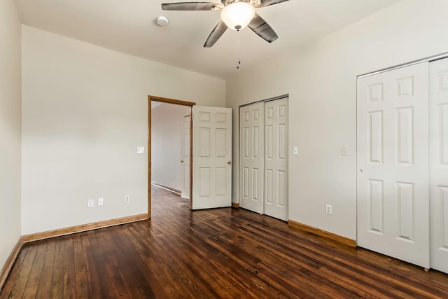 471 Southwood Ave, Columbus, OH 43207 - unfurnished bedroom featuring two closets, dark wood-type flooring, baseboards, and ceiling fan