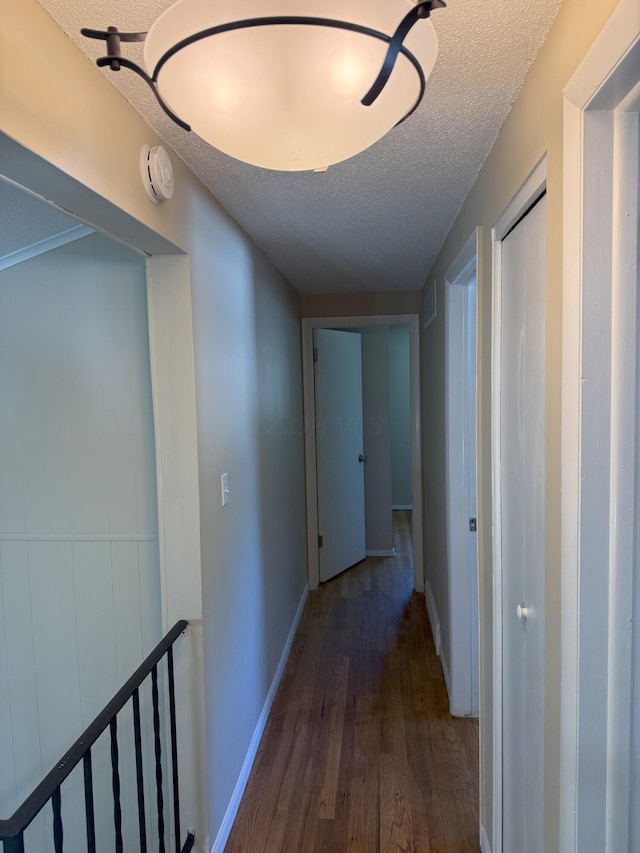 5123 Jameson Dr, Columbus, OH 43232 - corridor with wood finished floors, a textured ceiling, and baseboards