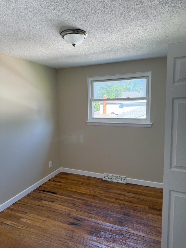 5123 Jameson Dr, Columbus, OH 43232 - empty room featuring wood finished floors, baseboards, and a textured ceiling