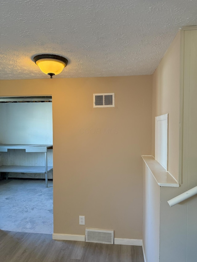 5123 Jameson Dr, Columbus, OH 43232 - corridor with a textured ceiling, wood finished floors, and baseboards