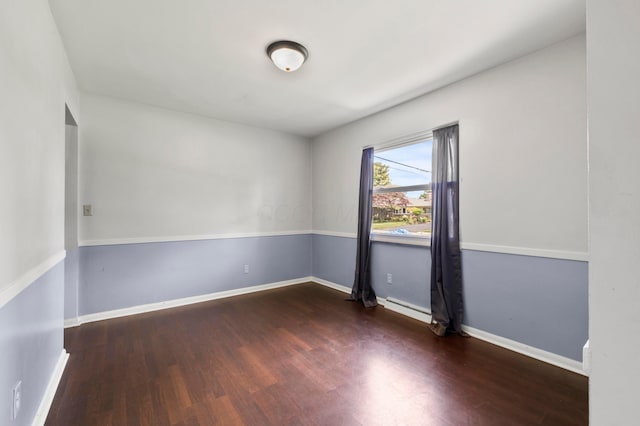 3191 S Stephen Dr, Columbus, OH 43204 - spare room featuring wood finished floors, baseboard heating, and baseboards