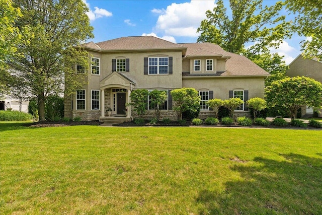 3144 Abbey Knoll Dr, Lewis Center, OH 43035 - traditional-style house featuring stucco siding, a front yard, and stone siding
