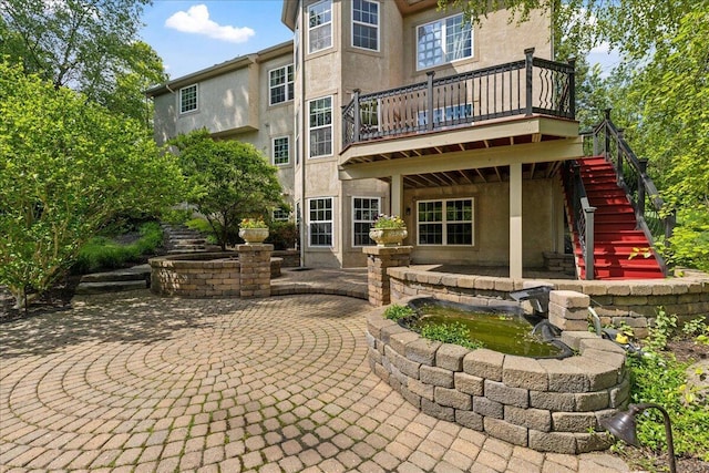 3144 Abbey Knoll Dr, Lewis Center, OH 43035 - back of property with stairway, stucco siding, a patio, and a deck