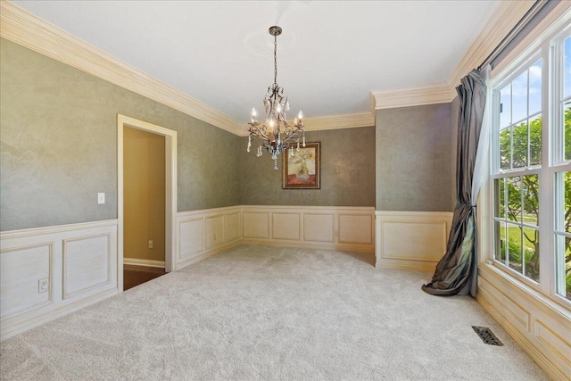3144 Abbey Knoll Dr, Lewis Center, OH 43035 - carpeted empty room with healthy amount of natural light, crown molding, a chandelier, wainscoting, and a decorative wall