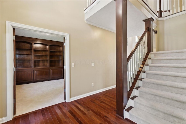 3144 Abbey Knoll Dr, Lewis Center, OH 43035 - staircase featuring hardwood / wood-style floors, baseboards, and a towering ceiling