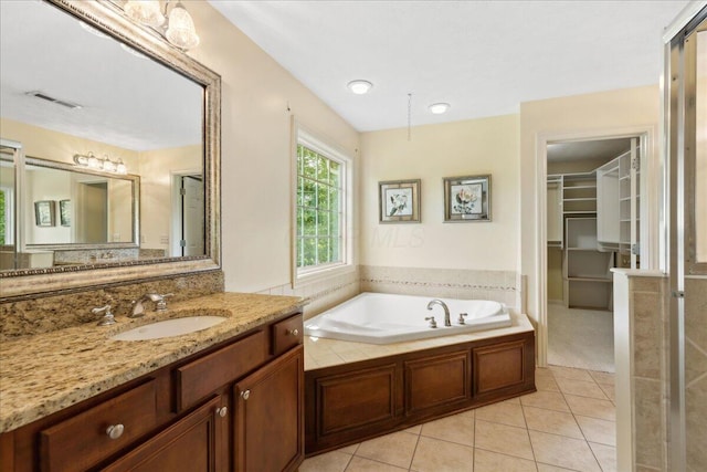 3144 Abbey Knoll Dr, Lewis Center, OH 43035 - bathroom with tile patterned floors, a bath, vanity, and a walk in closet