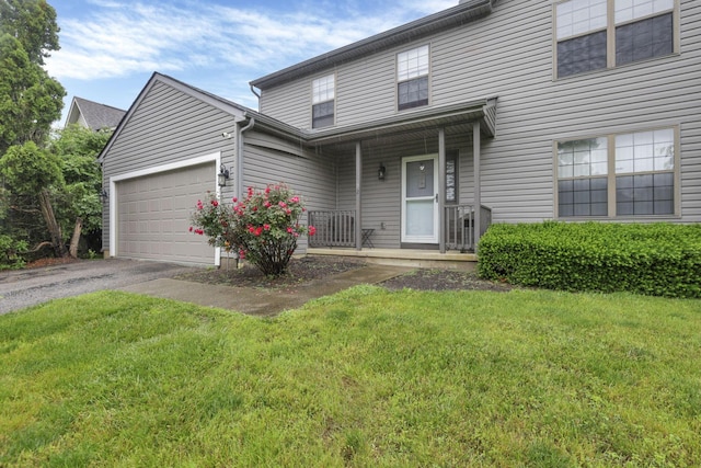 6792 Makady Rd, Canal Winchester, OH 43110 - traditional-style house featuring asphalt driveway, covered porch, an attached garage, and a front yard