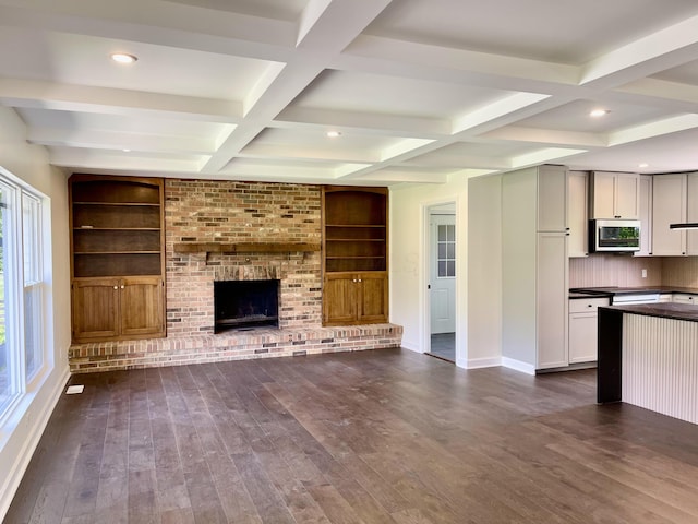 1071 US-42, London, OH 43140 - unfurnished living room featuring coffered ceiling, dark wood finished floors, baseboards, built in features, and beamed ceiling