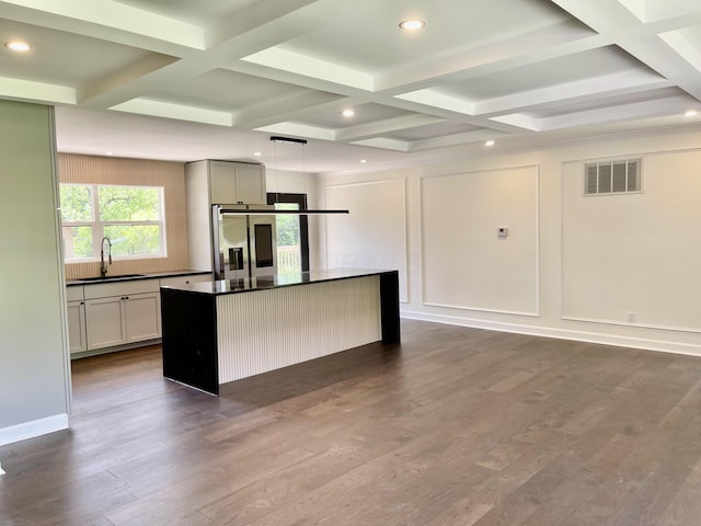 1071 US-42, London, OH 43140 - kitchen with stainless steel fridge, dark countertops, coffered ceiling, a center island, and a sink
