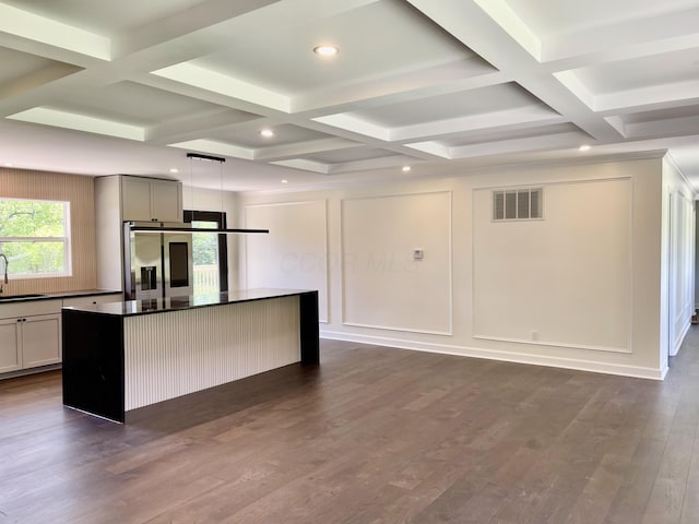 1071 US-42, London, OH 43140 - kitchen featuring stainless steel fridge, dark countertops, a sink, coffered ceiling, and a center island