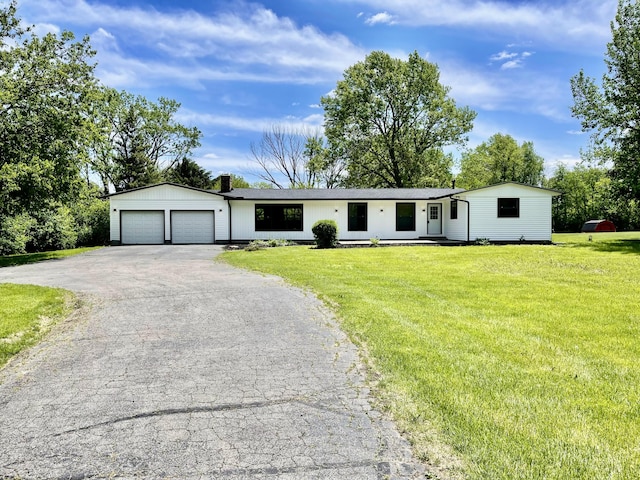 1071 US-42, London, OH 43140 - ranch-style house with an attached garage, asphalt driveway, a front yard, and a chimney