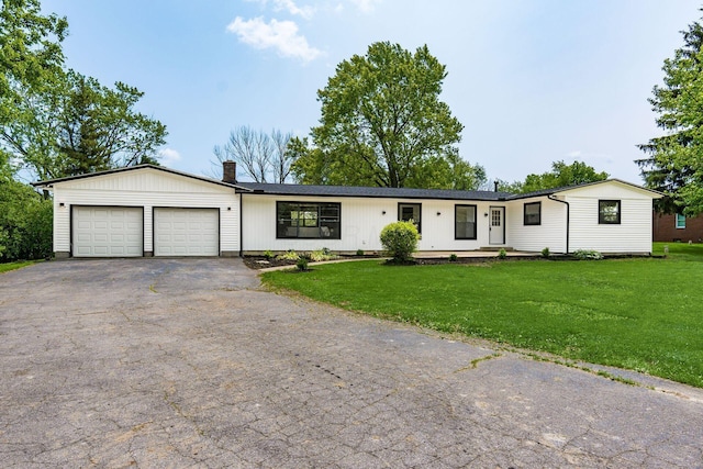 1071 US-42, London, OH 43140 - ranch-style house featuring a garage, asphalt driveway, a chimney, and a front yard