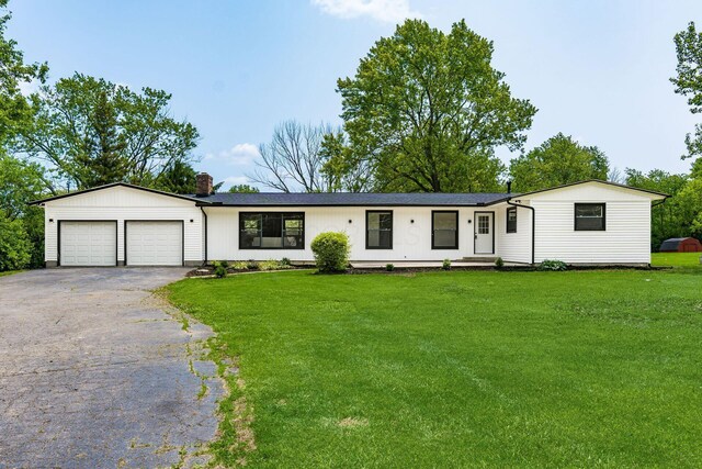 1071 US-42, London, OH 43140 - ranch-style home featuring driveway, an attached garage, a chimney, and a front lawn