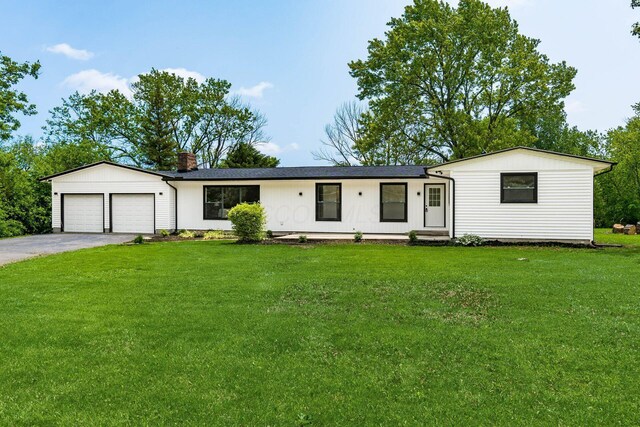 1071 US-42, London, OH 43140 - single story home featuring an attached garage, a chimney, asphalt driveway, and a front lawn