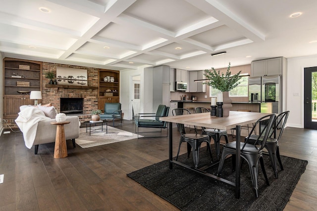 1071 US-42, London, OH 43140 - dining room featuring dark wood-type flooring, coffered ceiling, beamed ceiling, a fireplace, and recessed lighting
