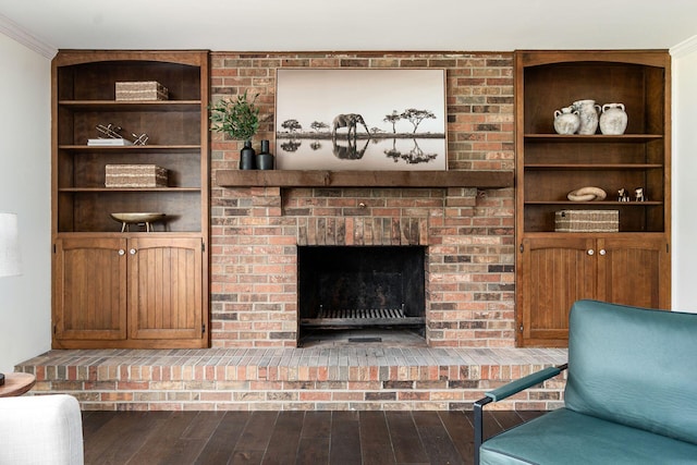 1071 US-42, London, OH 43140 - living area featuring wood finished floors, crown molding, a fireplace, and built in shelves