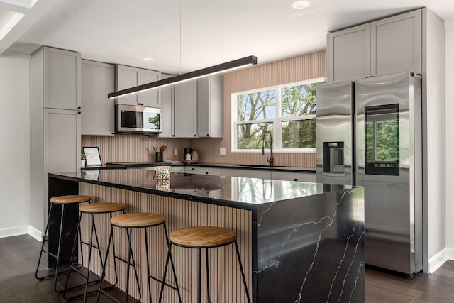 1071 US-42, London, OH 43140 - kitchen with appliances with stainless steel finishes, a sink, dark wood finished floors, baseboards, and gray cabinetry