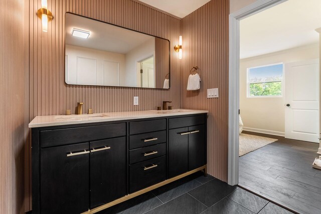 1071 US-42, London, OH 43140 - bathroom featuring double vanity, wood finished floors, and baseboards
