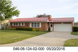 41 Mickey Rd, Shelby, OH 44875 - ranch-style house with a garage, concrete driveway, a front yard, and a chimney