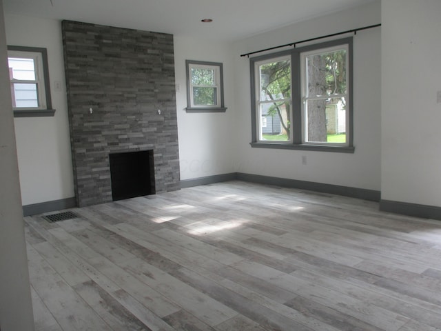 1056 Geers Ave, Columbus, OH 43206 - unfurnished living room featuring a large fireplace, wood finished floors, and baseboards