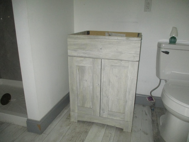 1056 Geers Ave, Columbus, OH 43206 - bathroom featuring toilet, wood finished floors, and baseboards