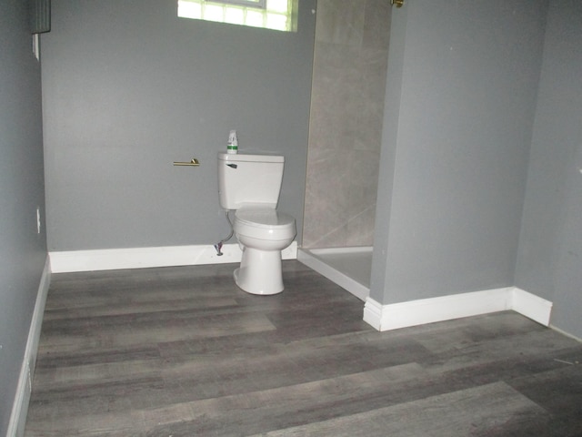 1056 Geers Ave, Columbus, OH 43206 - full bath featuring toilet, wood finished floors, baseboards, and a shower