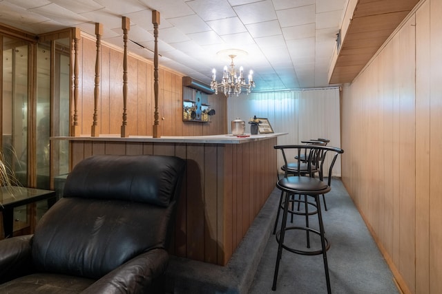 2929 Fairwood Ave, Columbus, OH 43205 - bar area featuring carpet, wood walls, and a chandelier