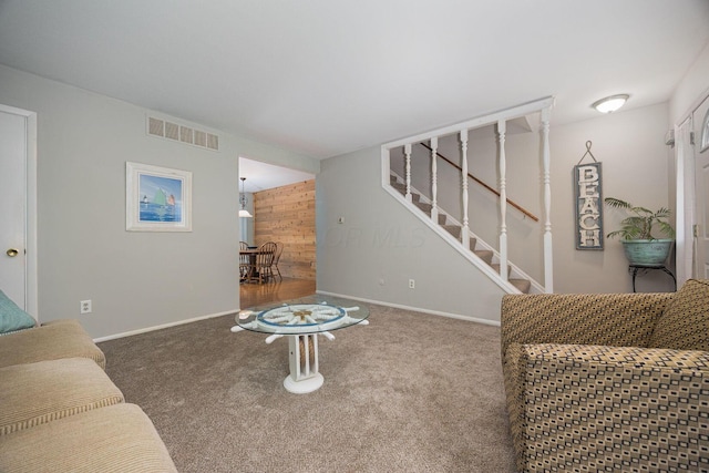 2349 Hardesty Dr N Unit B9, Columbus, OH 43204 - carpeted living room with stairs, baseboards, and wooden walls