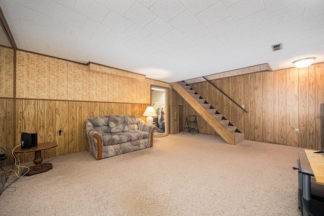 2349 Hardesty Dr N Unit B9, Columbus, OH 43204 - carpeted living area featuring wooden walls, stairway, and wallpapered walls