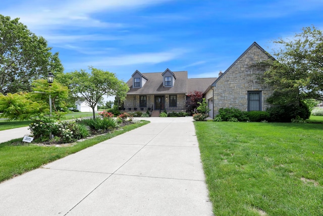 3171 Orders Rd, Grove City, OH 43123 - new england style home featuring stone siding, a front yard, and a porch
