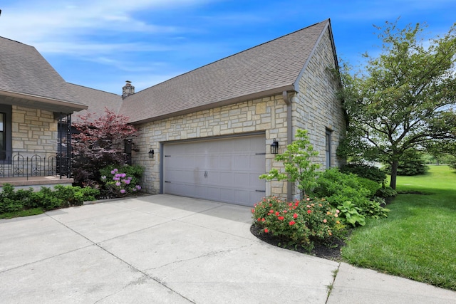 3171 Orders Rd, Grove City, OH 43123 - view of side of property featuring stone siding, roof with shingles, an attached garage, and a lawn