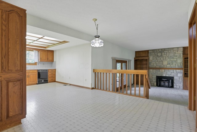 3171 Orders Rd, Grove City, OH 43123 - unfurnished living room with baseboards and a stone fireplace