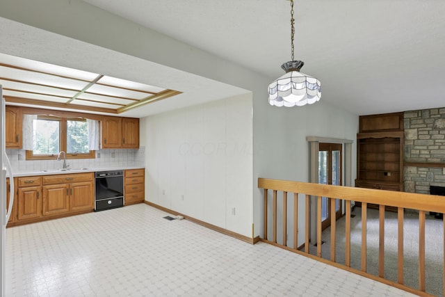 3171 Orders Rd, Grove City, OH 43123 - kitchen featuring black dishwasher, a sink, light countertops, hanging light fixtures, and brown cabinets
