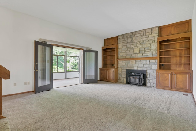 3171 Orders Rd, Grove City, OH 43123 - unfurnished living room featuring built in features, carpet, baseboards, french doors, and a wood stove
