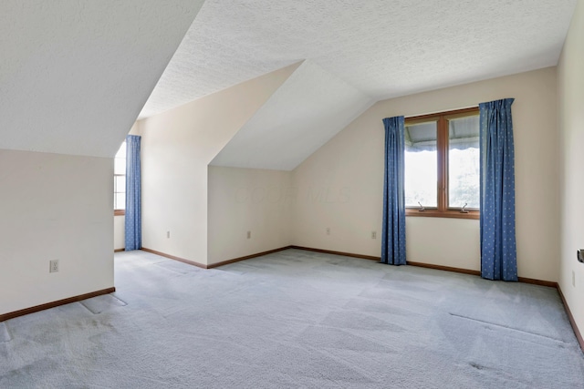 3171 Orders Rd, Grove City, OH 43123 - additional living space with carpet flooring, lofted ceiling, baseboards, and a textured ceiling