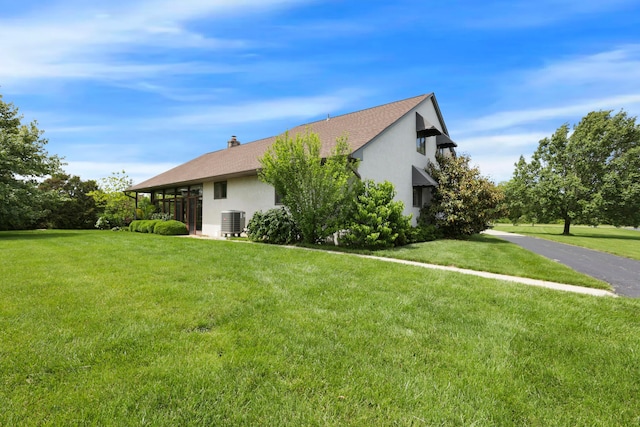 3171 Orders Rd, Grove City, OH 43123 - view of property exterior with central AC unit, stucco siding, a yard, and a shingled roof