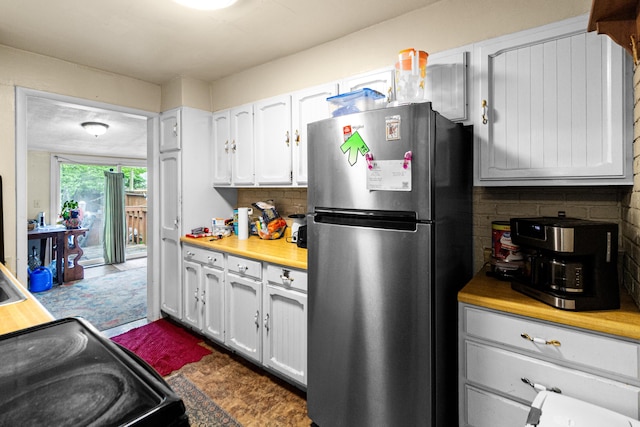 2720 Audubon Rd, Columbus, OH 43211 - kitchen with freestanding refrigerator, white cabinetry, decorative backsplash, light countertops, and range with electric cooktop