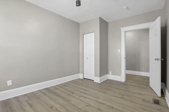 1120 8th Ave, Lancaster, OH 43130 - unfurnished bedroom featuring wood finished floors, baseboards, a ceiling fan, and a closet