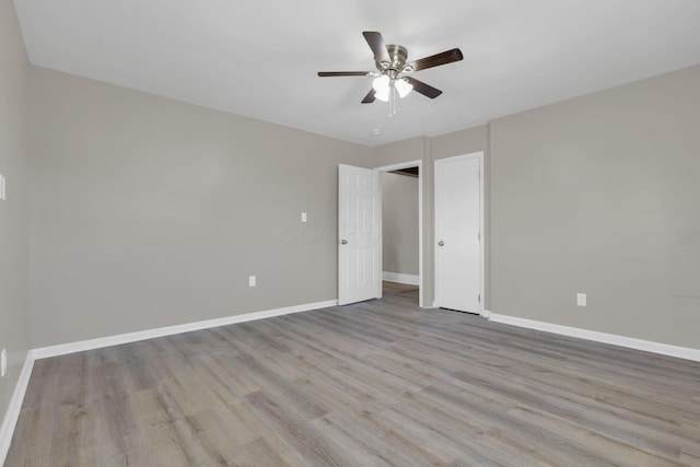 1120 8th Ave, Lancaster, OH 43130 - unfurnished bedroom with wood finished floors, baseboards, and a ceiling fan