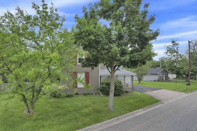 402 W St, Groveport, OH 43125 - view of property hidden behind natural elements with a front lawn and asphalt driveway