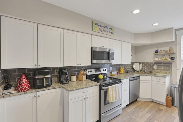 402 W St, Groveport, OH 43125 - kitchen with stainless steel appliances, white cabinetry, open shelves, backsplash, and recessed lighting