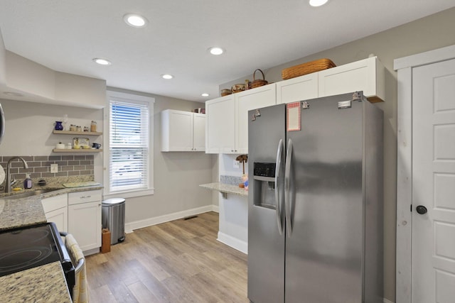 402 W St, Groveport, OH 43125 - kitchen with stainless steel fridge with ice dispenser, a sink, light stone countertops, white cabinetry, and recessed lighting