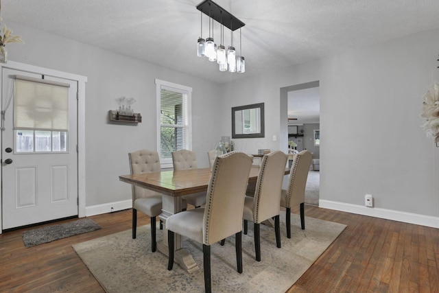402 W St, Groveport, OH 43125 - dining area with baseboards, hardwood / wood-style flooring, and a textured ceiling