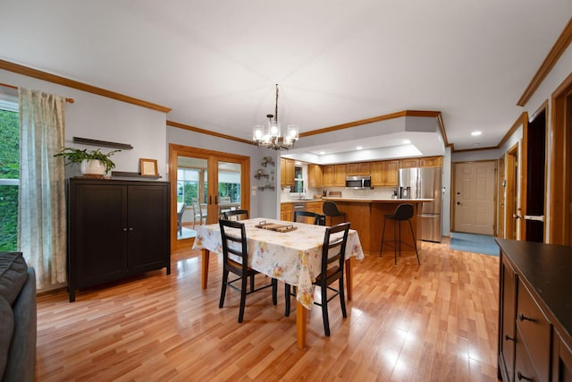 1055 Arcaro Dr, Columbus, OH 43230 - dining space featuring light wood-type flooring, a chandelier, ornamental molding, and recessed lighting