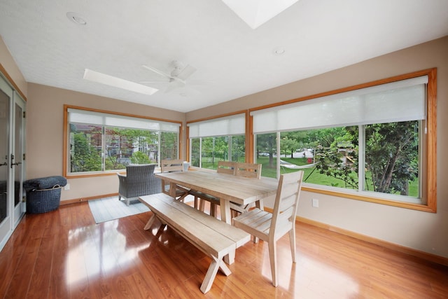 1055 Arcaro Dr, Columbus, OH 43230 - sunroom / solarium featuring a skylight, baseboards, wood finished floors, and plenty of natural light