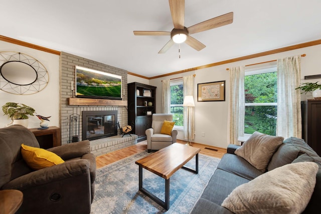 1055 Arcaro Dr, Columbus, OH 43230 - living room with healthy amount of natural light, ceiling fan, a brick fireplace, wood finished floors, and crown molding
