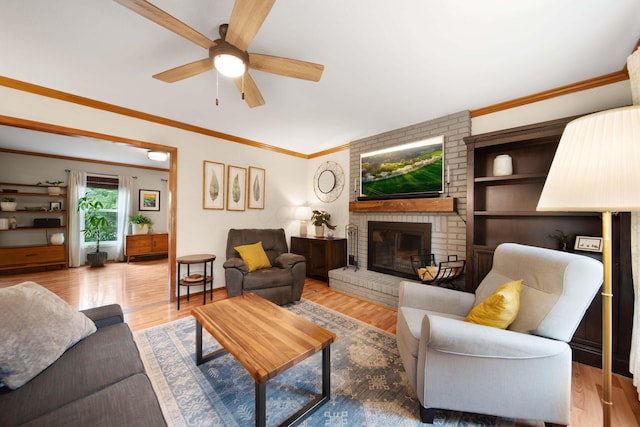 1055 Arcaro Dr, Columbus, OH 43230 - living room featuring a ceiling fan, a fireplace, crown molding, and wood finished floors